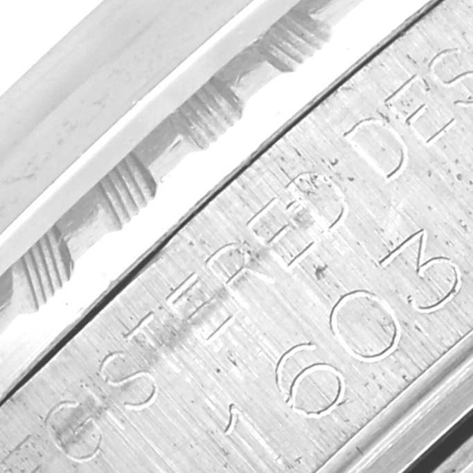 The image shows a close-up of the engraved side detail of the Rolex Vintage Collection 1603 Men's Stainless Steel Silver Dial 1603 Men's Stainless Steel Silver Dial watch.