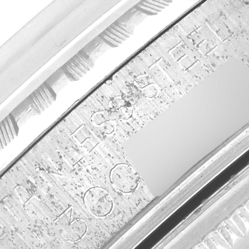 The image shows a close-up of the case edge and engraved writing on a Rolex Vintage Collection 1603 Men's Stainless Steel Silver Dial 1603 Men's Stainless Steel Silver Dial watch.