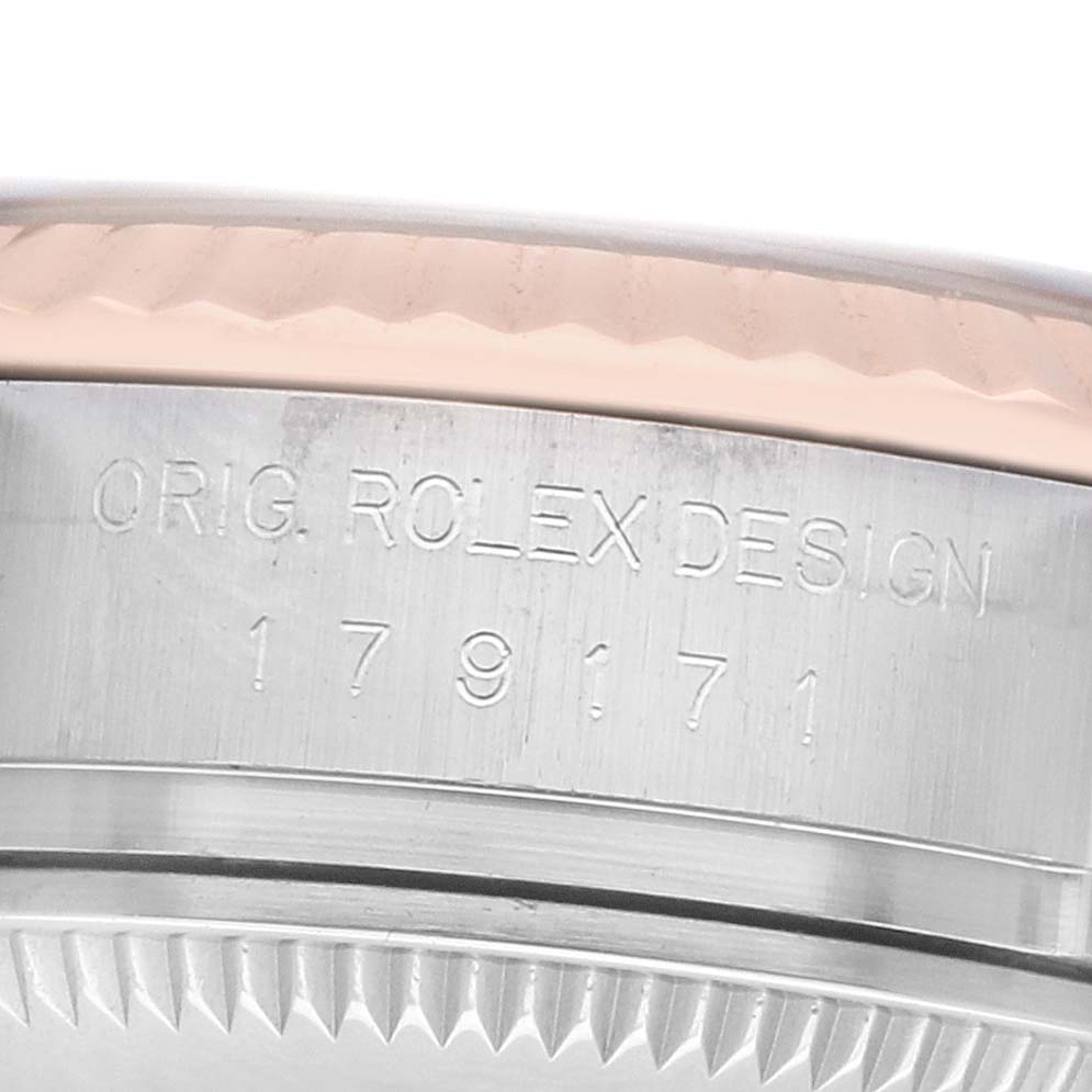 The image shows a close-up of the side of a Rolex Datejust 179171 Women
s Steel and Gold (two tone) Black Dial, focusing on the engraved case details.