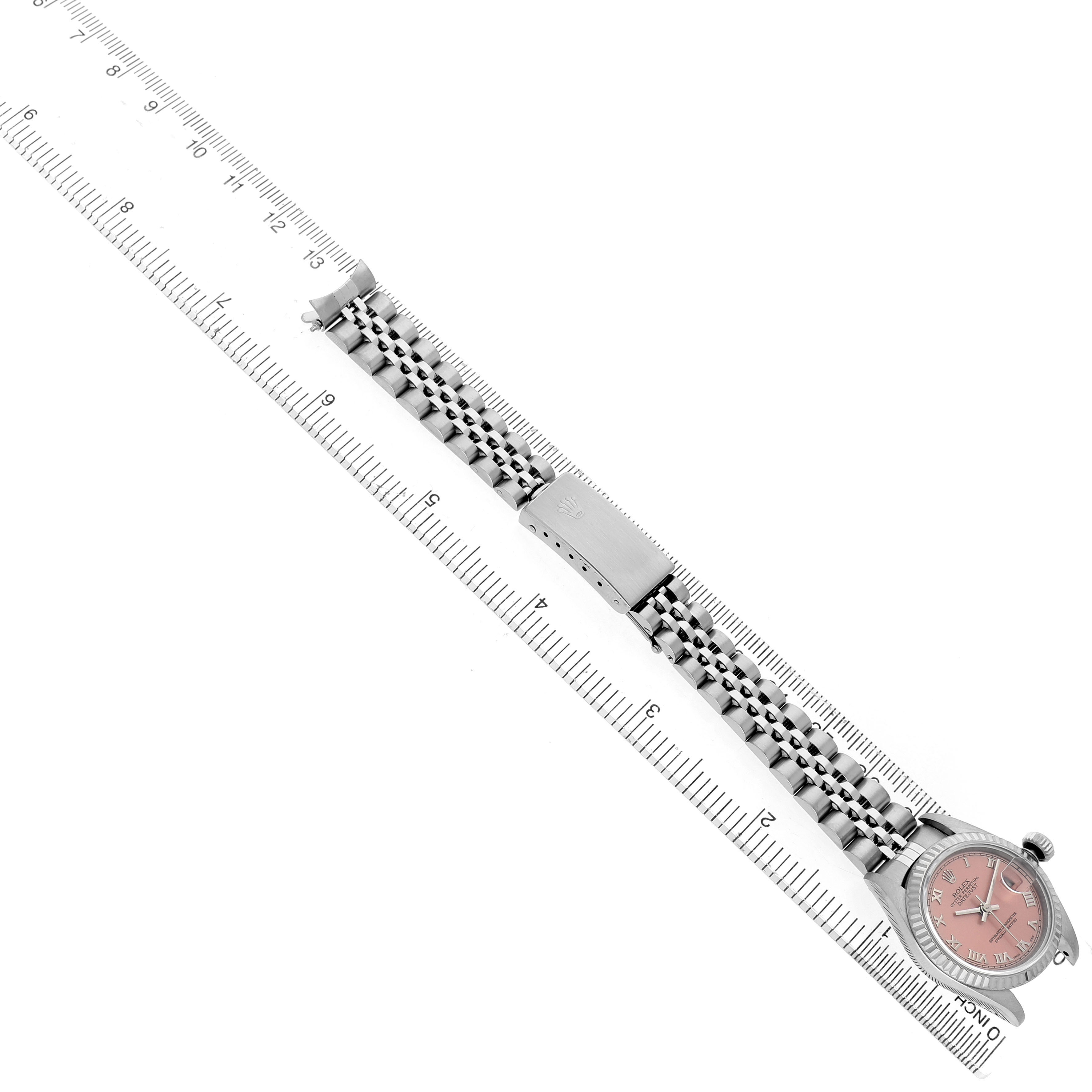 The image shows a top-down view of a Rolex Datejust 69174 Women's Stainless Steel Pink Dial watch with its bracelet aligned on a ruler.