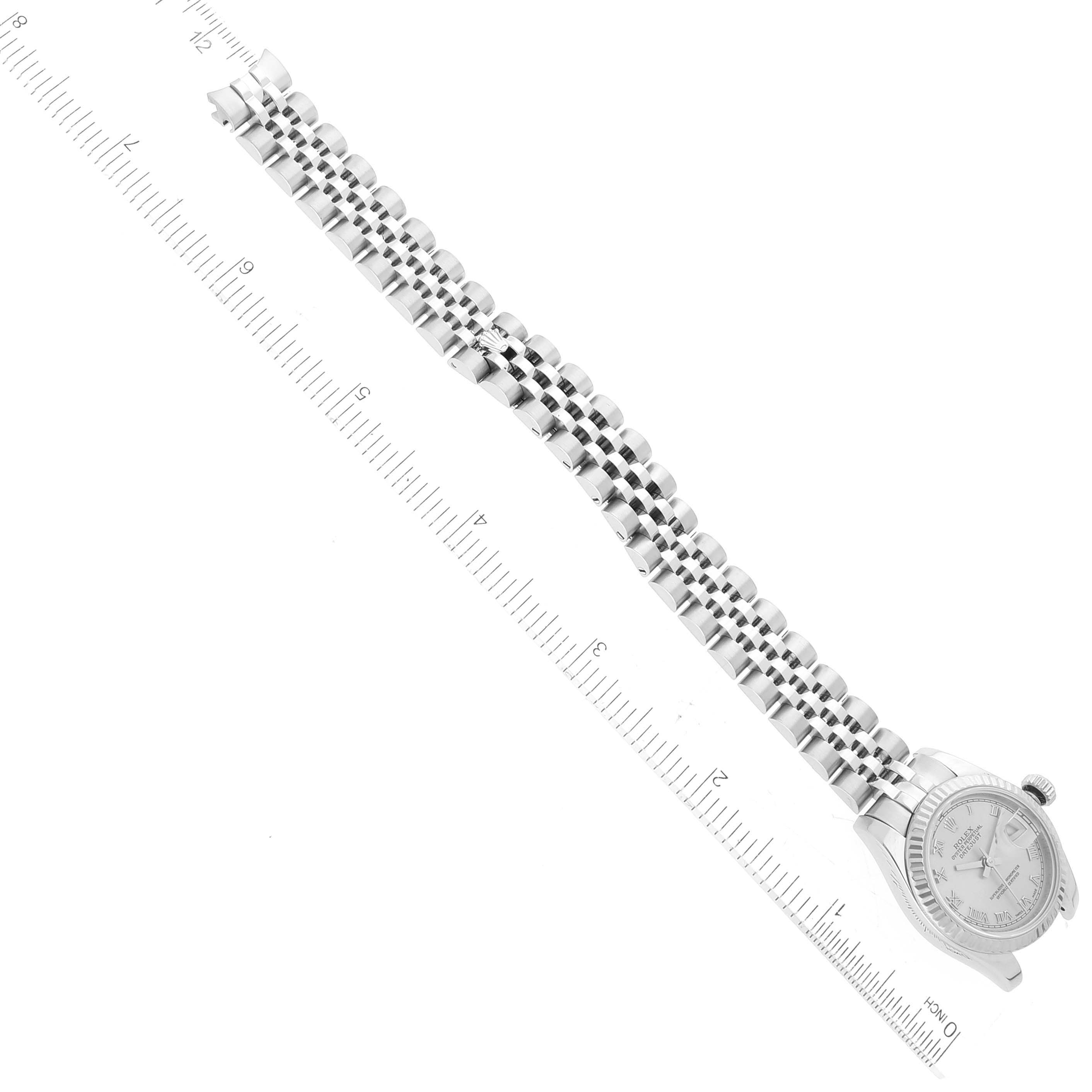 The image shows a top-down view of the Rolex Datejust 179174 Women's Stainless Steel Silver Dial 179174 Women's Stainless Steel Silver Dial watch and its bracelet, positioned beside a ruler.