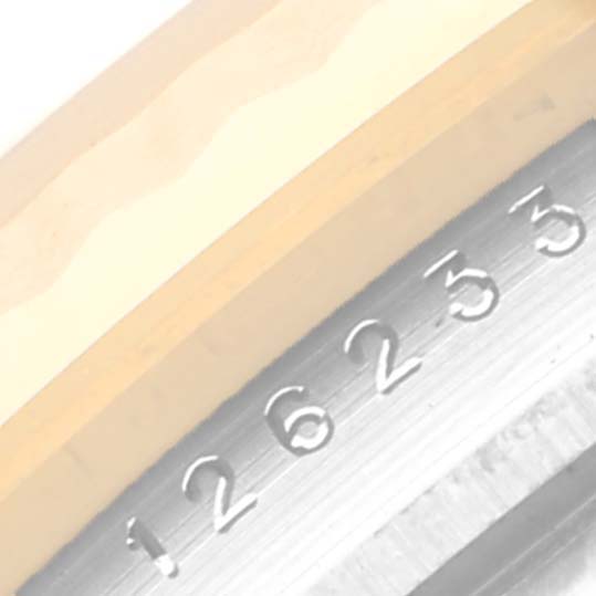 The image shows a close-up of the Rolex Datejust 126233 Men
s Steel and Gold (two tone) Silver Dial model
s case side, highlighting the serial number engraving.