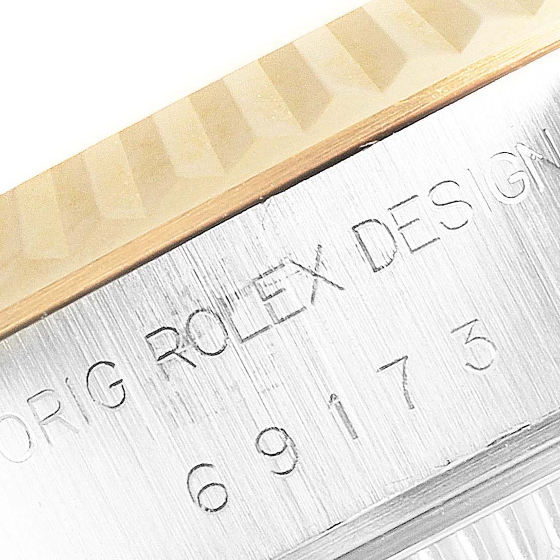 The image shows a close-up of the bezel and inscription on the case of a Rolex Datejust 69173 Women's Steel and Gold (two tone) Black Dial 69173 Women's Steel and Gold (two tone) Black Dial watch.