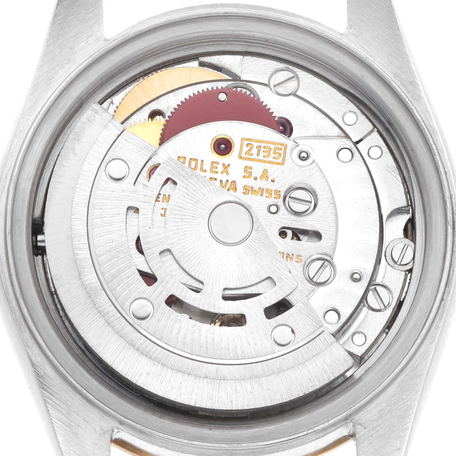 The image shows the back view of a Rolex Datejust 69173 Women
s Steel and Gold (two tone) Champagne Dial, focusing on its intricate internal movement and rotor.