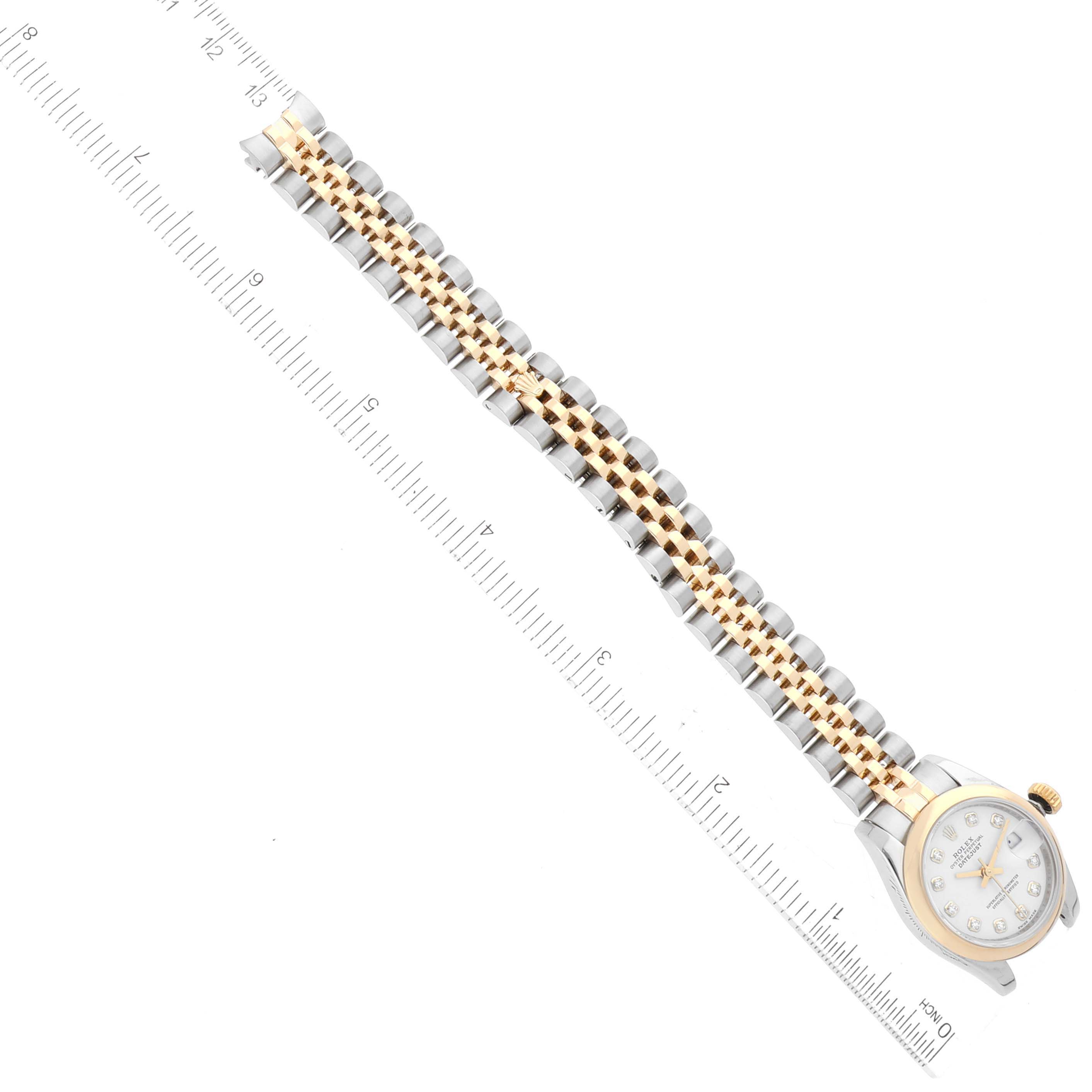 This image shows a Rolex Datejust 179163 Women's Steel and Gold (two tone) White Dial 179163 Women's Steel and Gold (two tone) White Dial watch laid flat with the band extended and aligned with a ruler for measurement.