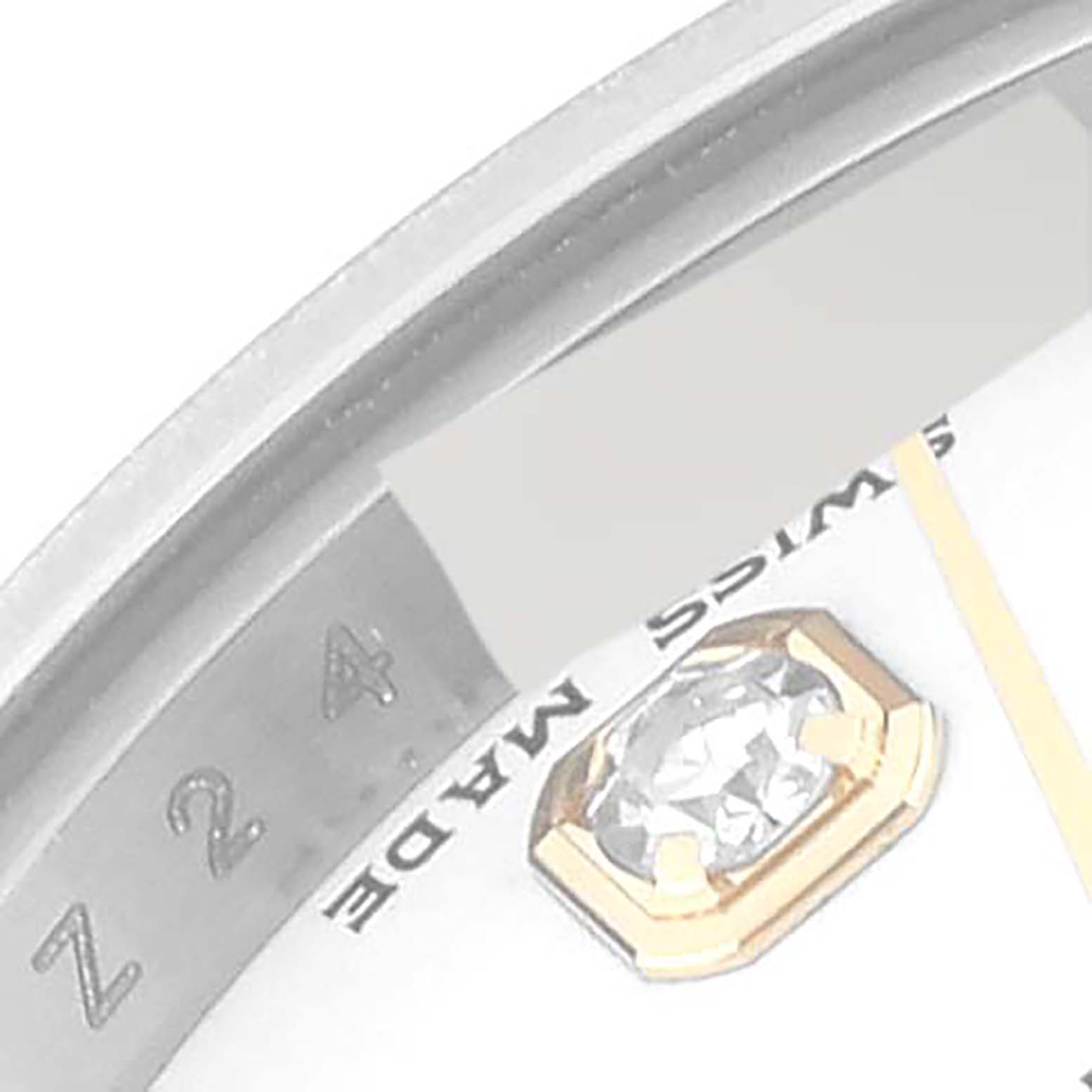 This is a close-up of the dial and bezel of a Rolex Datejust 179163 Women's Steel and Gold (two tone) White Dial 179163 Women's Steel and Gold (two tone) White Dial, showing the "SWISS MADE" text and a diamond marker.