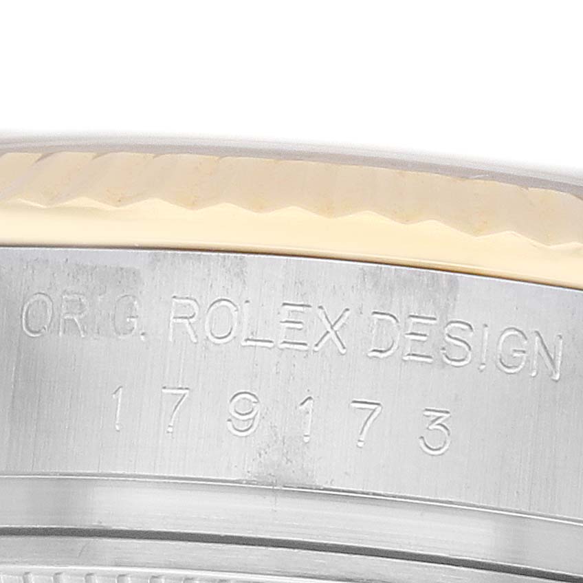 The image shows a close-up of the case edge and engraving on a Rolex Datejust 179173 Women
s Stainless Steel Champagne Dial.