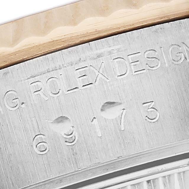 The image shows the side engraving on the case of a Rolex Datejust 69173 Women's Steel and Gold (two tone) Champagne Dial 69173 Women's Steel and Gold (two tone) Champagne Dial, including the model number and branding.