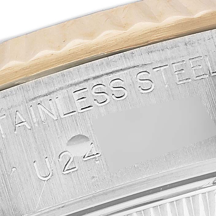 The image shows a close-up of the side of a Rolex Datejust 69173 Women's Steel and Gold (two tone) Champagne Dial 69173 Women's Steel and Gold (two tone) Champagne Dial watch with the serial number engraving.