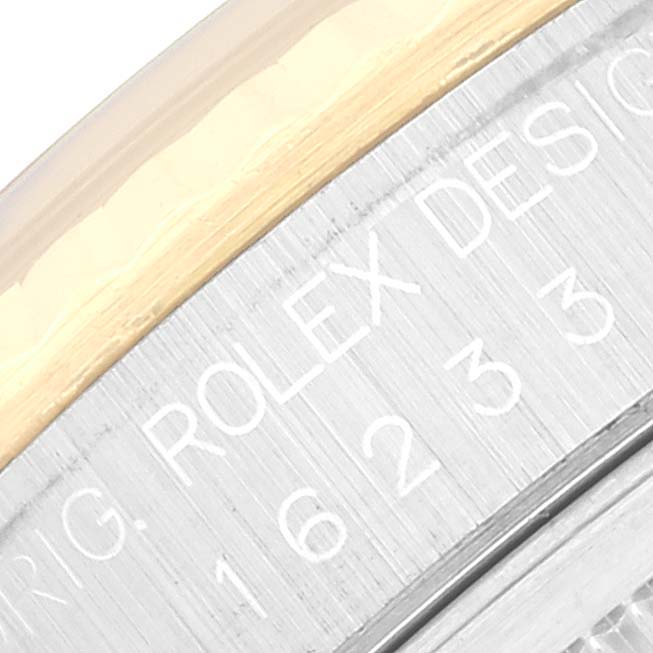 The image shows a close-up of the bezel and outer edge of the dial on a Rolex Datejust 16233 Men's Steel and Gold (two tone) Champagne Dial 16233 Men's Steel and Gold (two tone) Champagne Dial watch, featuring the engraved design serial number.