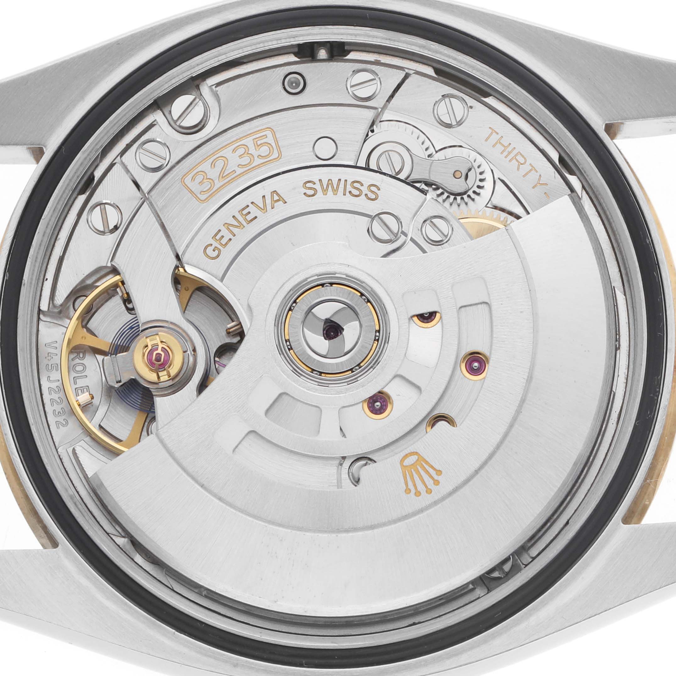 The image shows the intricate back view of the Rolex Datejust 126233 Men's Steel and Gold (two tone) Yellow Dial watch, focusing on the movement and mechanism details inside.