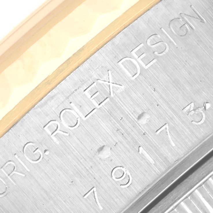The image shows a close-up of the Rolex Datejust 79173 Women's Steel and Gold (two tone) Beige Dial 79173 Women's Steel and Gold (two tone) Beige Dial model's engraved case side.