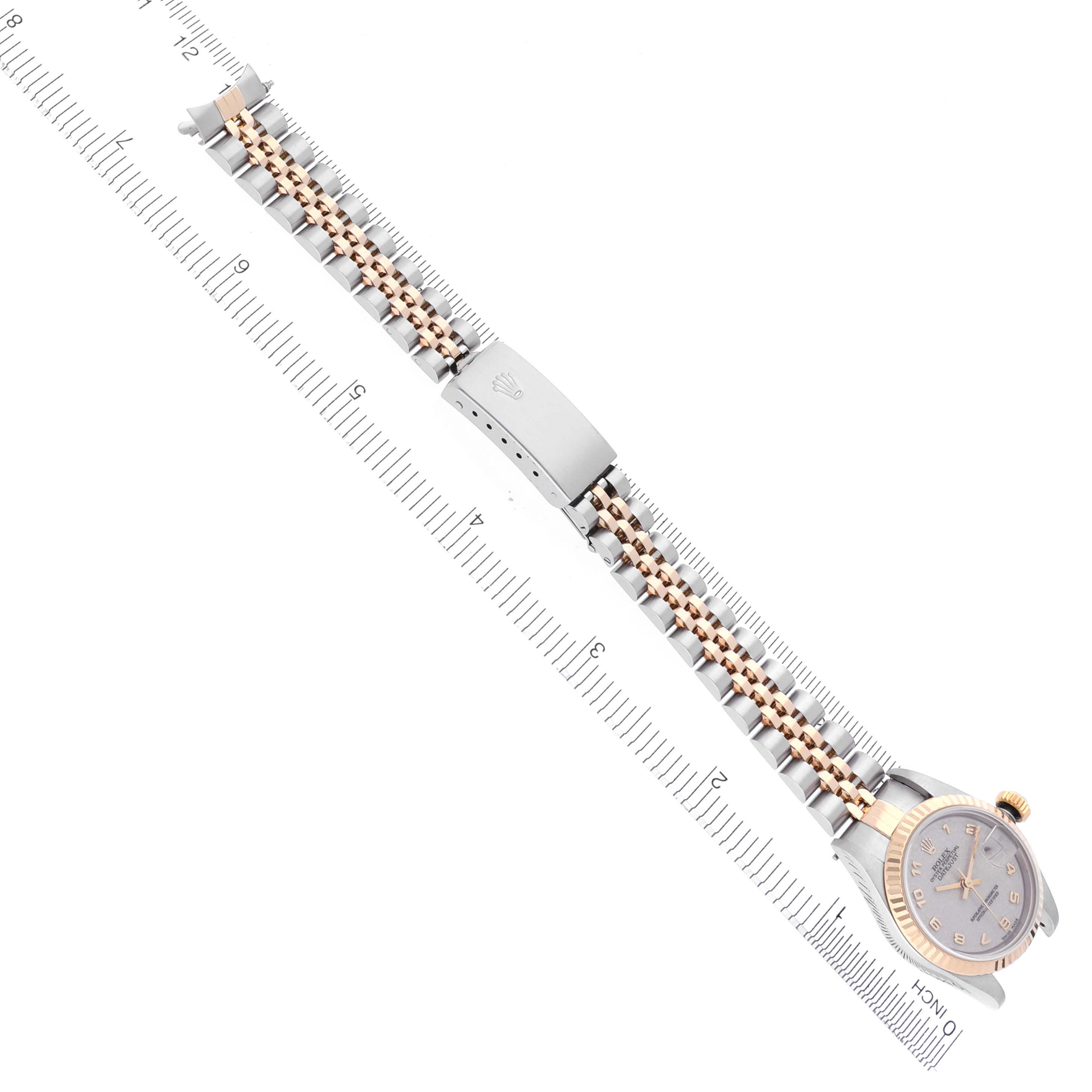 The image shows a top-down view of a Rolex Datejust 79173 Women's Steel and Gold (two tone) Beige Dial 79173 Women's Steel and Gold (two tone) Beige Dial watch with its bracelet laid flat next to a ruler.