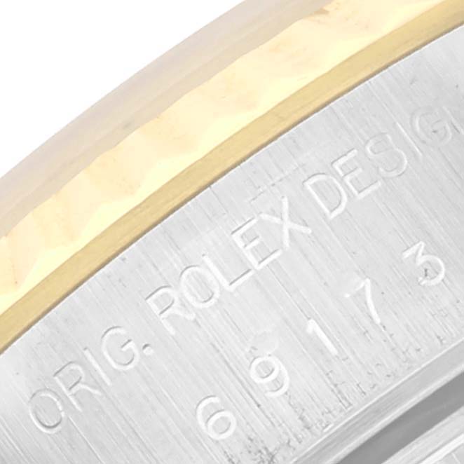 This image shows a close-up of the engraving on the side of a Rolex Datejust 69173 Women's Steel and Gold (two tone) White Dial 69173 Women's Steel and Gold (two tone) White Dial's case.