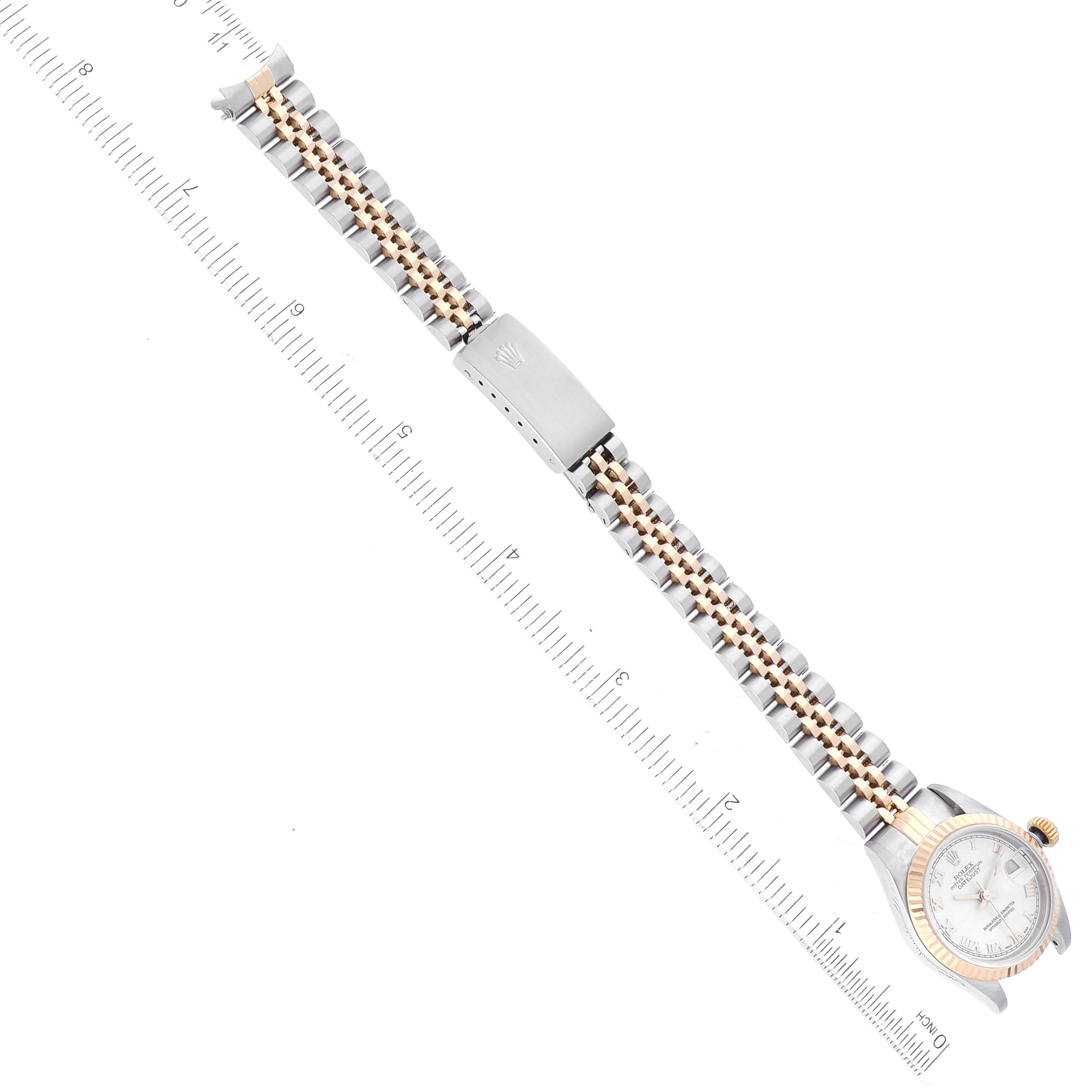 The image shows a top-down view of a Rolex Datejust 69173 Women's Steel and Gold (two tone) White Dial 69173 Women's Steel and Gold (two tone) White Dial watch, including the face, case, and bracelet, with a ruler alongside.