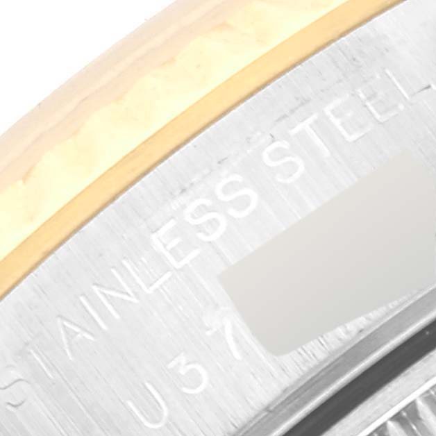 This close-up image of a Rolex Datejust 69173 Women's Steel and Gold (two tone) White Dial 69173 Women's Steel and Gold (two tone) White Dial watch shows part of the bezel and the engraved text on the stainless steel casing.
