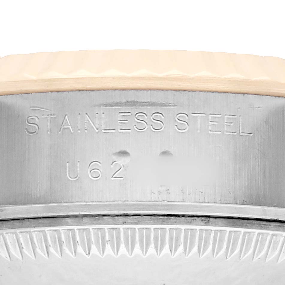 The image shows a close-up of the side of a Rolex Datejust 69173 Women
s Steel and Gold (two tone) White Dial, highlighting the stainless steel engraving.