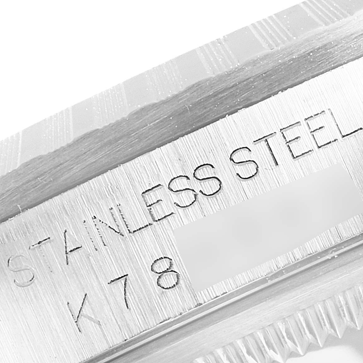 This is a close-up of the Rolex Datejust 16220 Men's Stainless Steel White Dial 16220 Men's Stainless Steel White Dial model's stainless steel case and partially visible bezel.