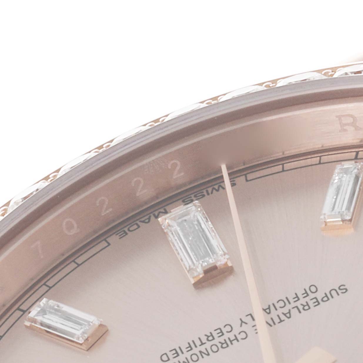 The image shows a close-up of the Rolex President 228345 Men's Rose Gold Pink Dial 228345 Men's Rose Gold Pink Dial dial, focusing on the bezel and diamond hour markers.