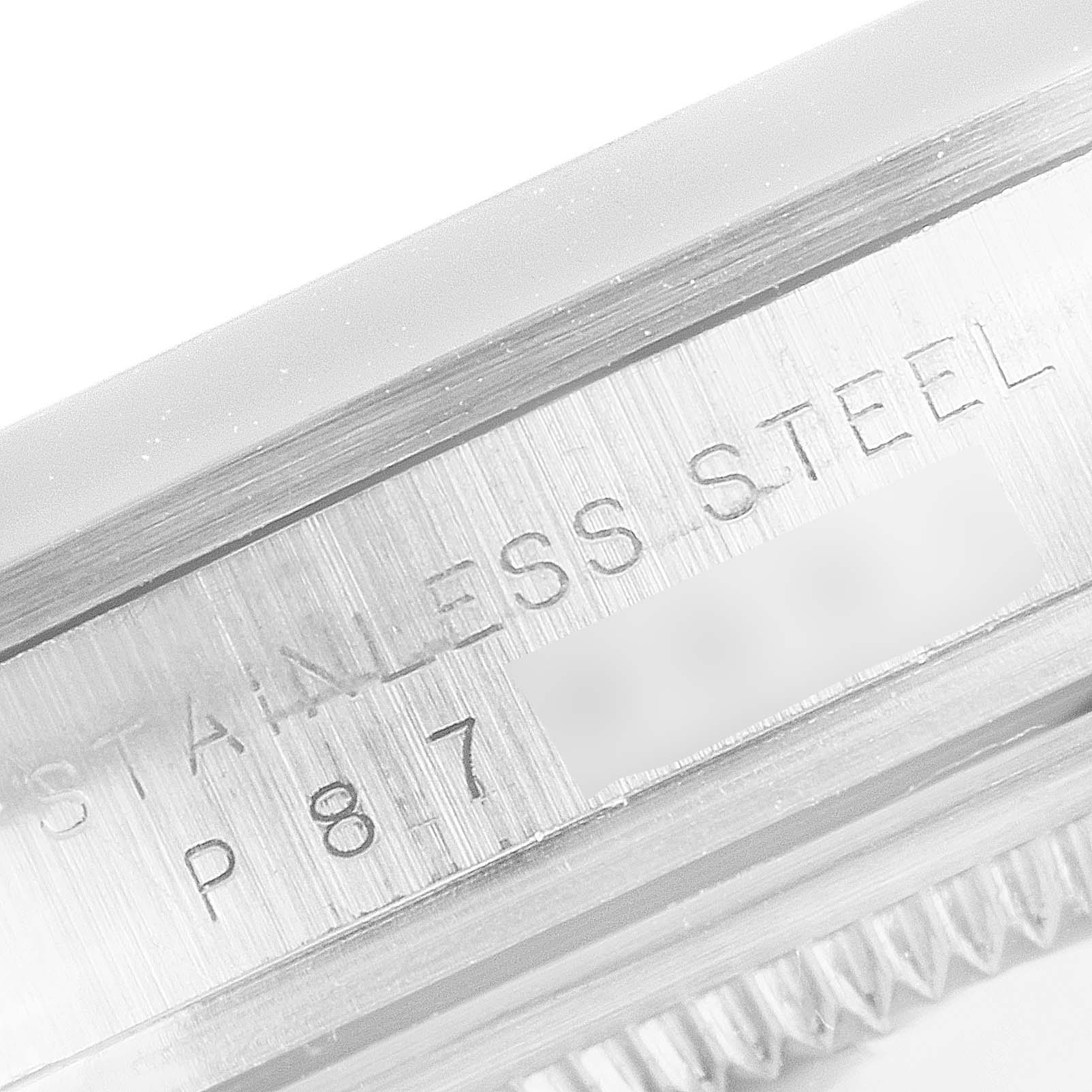 This close-up image shows the side engraving on a stainless steel case of a Rolex Explorer 114270 Men
s Stainless Steel Black Dial 114270 Men
s Stainless Steel Black Dial watch.