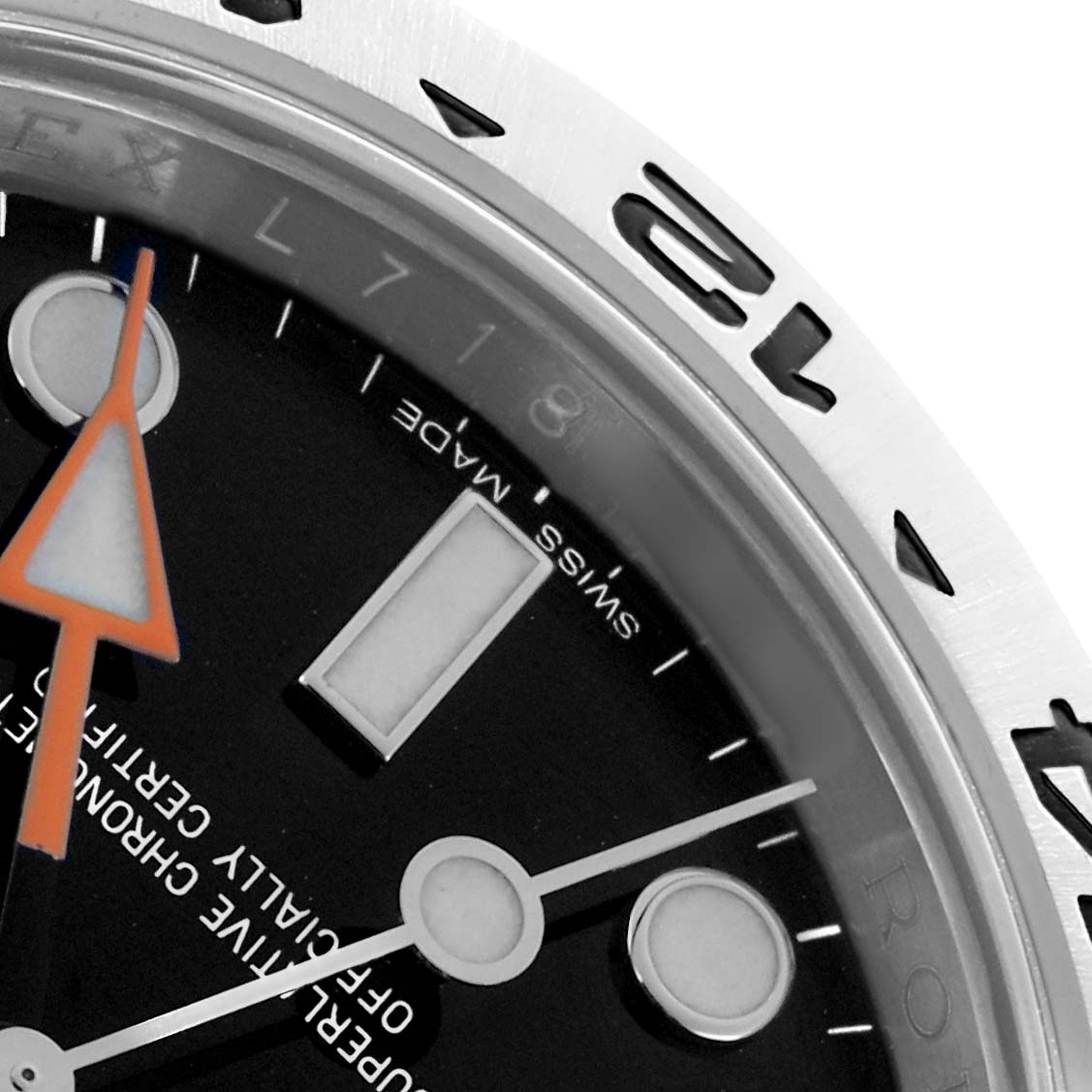 The image shows a close-up of the Rolex Explorer 216570 Men
s Stainless Steel Black Dial watch dial and bezel, highlighting the hour markers and orange GMT hand.