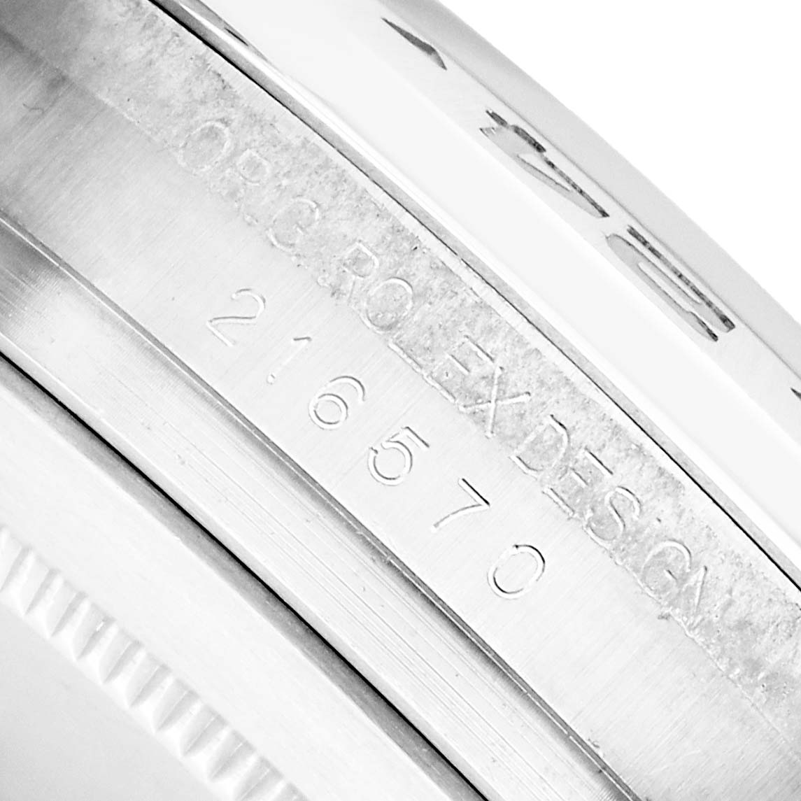 The image shows a close-up of the inner bezel engraving of the Rolex Explorer 216570 Men
s Stainless Steel Black Dial model, displaying its reference number.