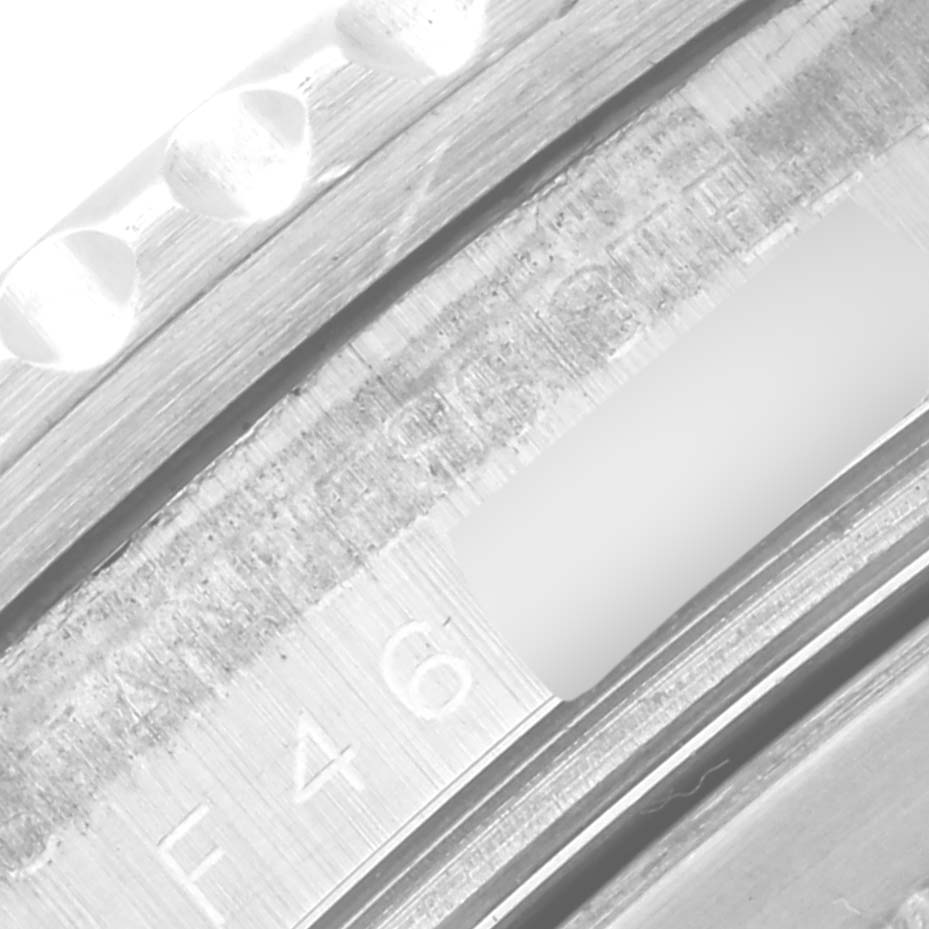 The image shows a close-up of the inner bezel edge of the Rolex GMT-Master 16710 Men
s Stainless Steel Black Dial 16710 Men
s Stainless Steel Black Dial, displaying engraved serial numbers and part of the rehaut.