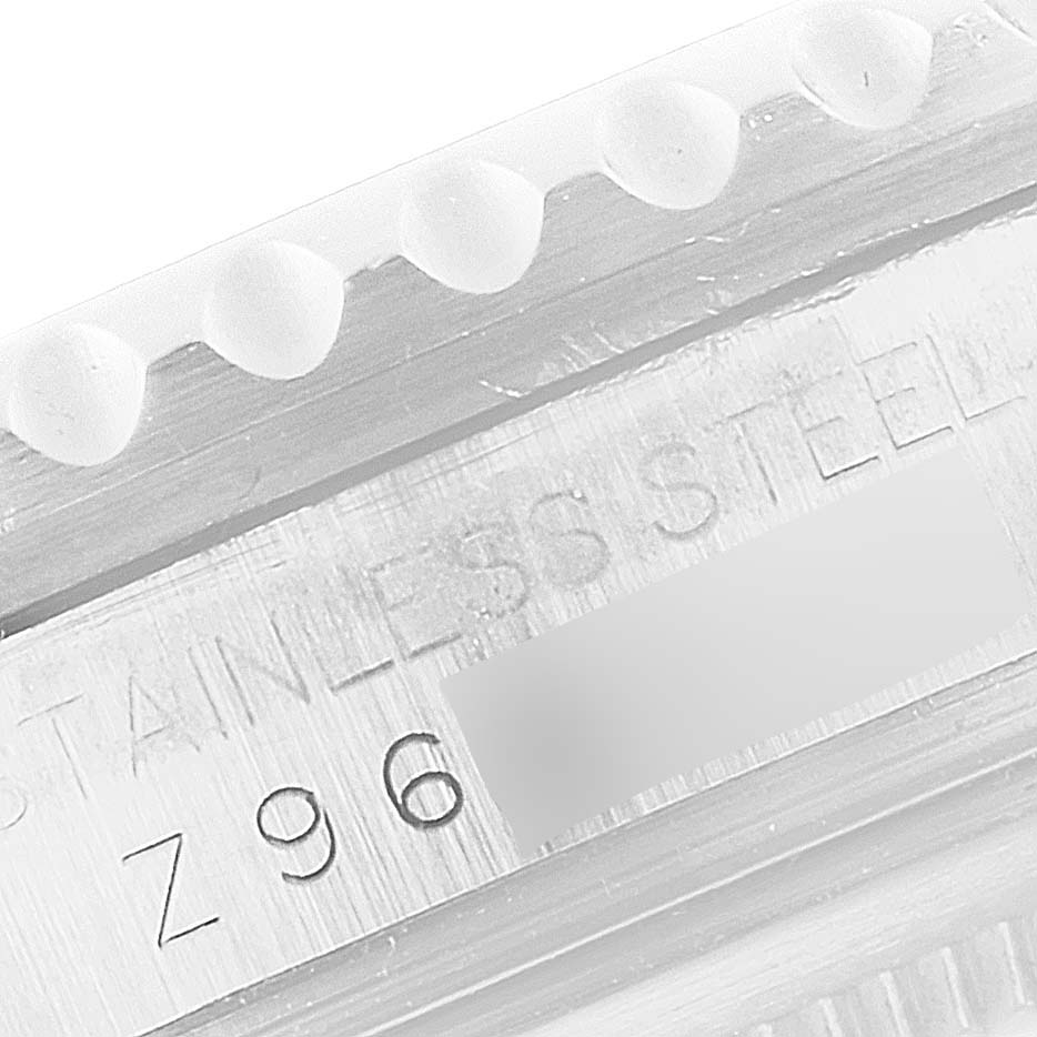 Close-up of the case side of a Rolex GMT-Master 16710 Men's Stainless Steel Black Dial 16710 Men's Stainless Steel Black Dial, showing part of the stainless steel casing and the serial number.