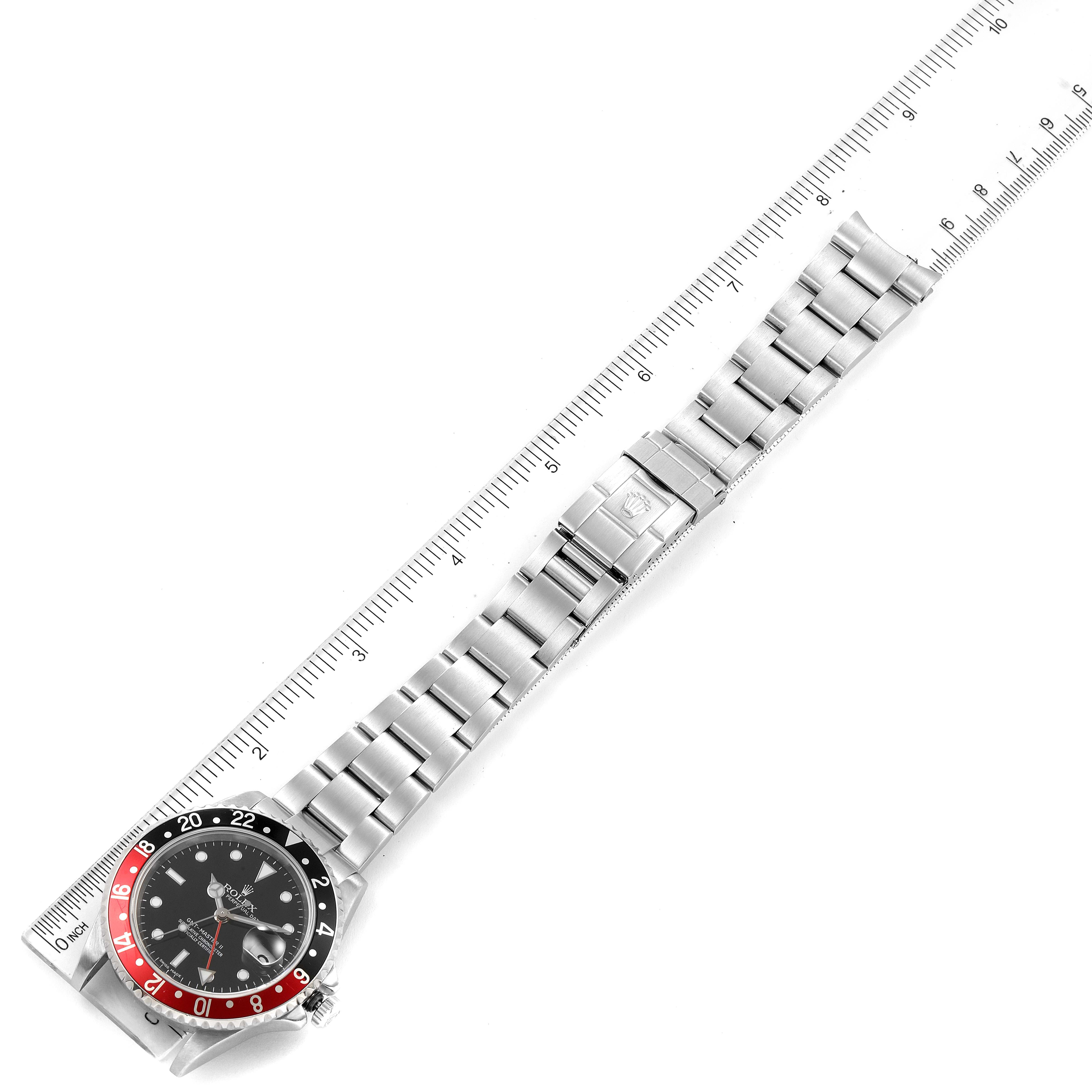 The image shows a top-down view of the Rolex GMT-Master 16710 Men's Stainless Steel Black Dial 16710 Men's Stainless Steel Black Dial watch with a metal bracelet next to a measuring ruler.