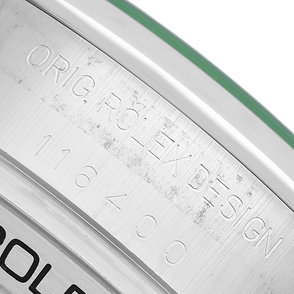 The image shows a close-up of the Milgauss model by Rolex, featuring the engraved reference number and branding on the case.