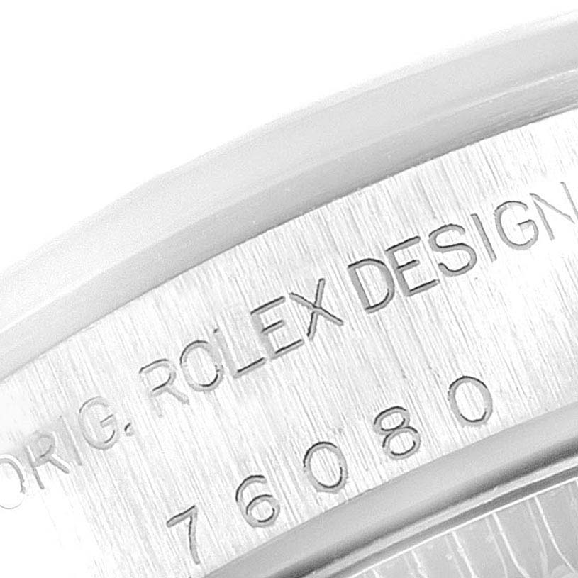This image shows a close-up of the case back edge of a Rolex Oyster Perpetual 76080 Women's Stainless Steel Pink Dial 76080 Women's Stainless Steel Pink Dial watch, displaying the engraved text.