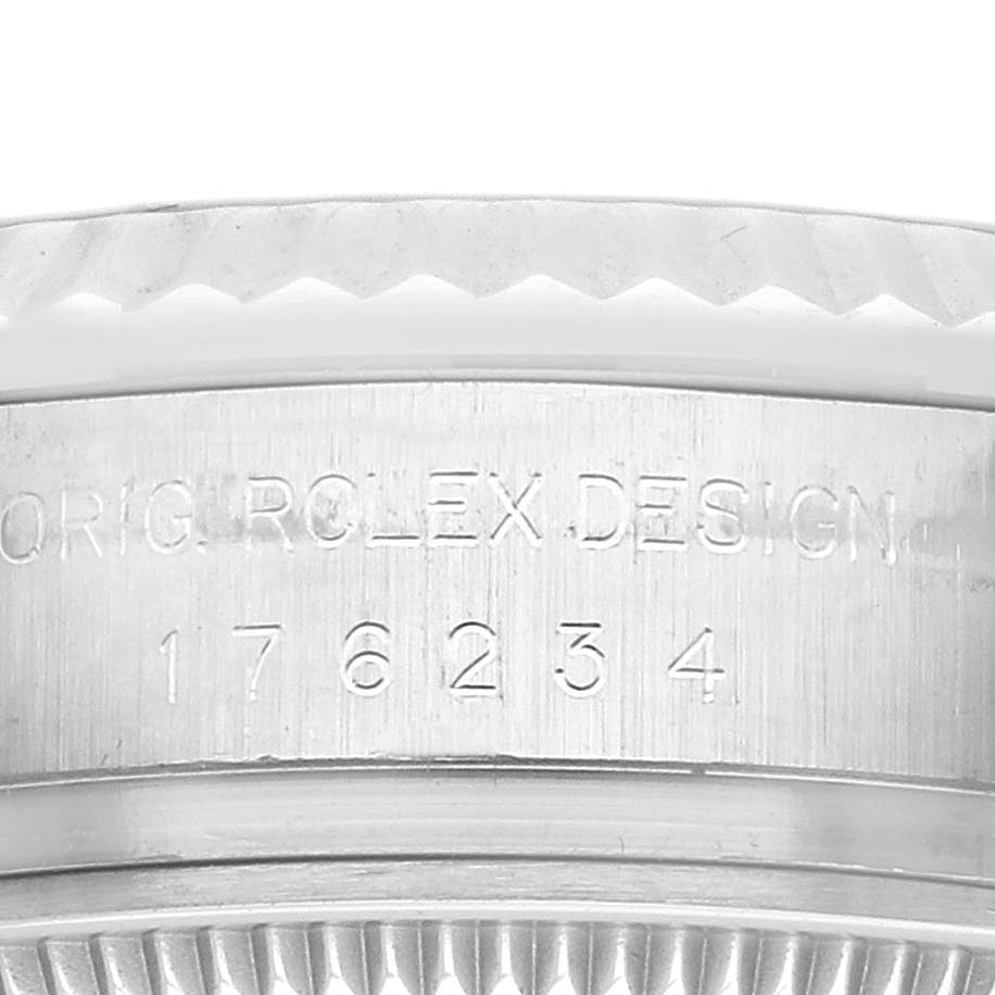 The image shows a close-up of the engraved bezel edge of a Rolex Oyster Perpetual 176234 Women
s Stainless Steel Silver Dial watch.