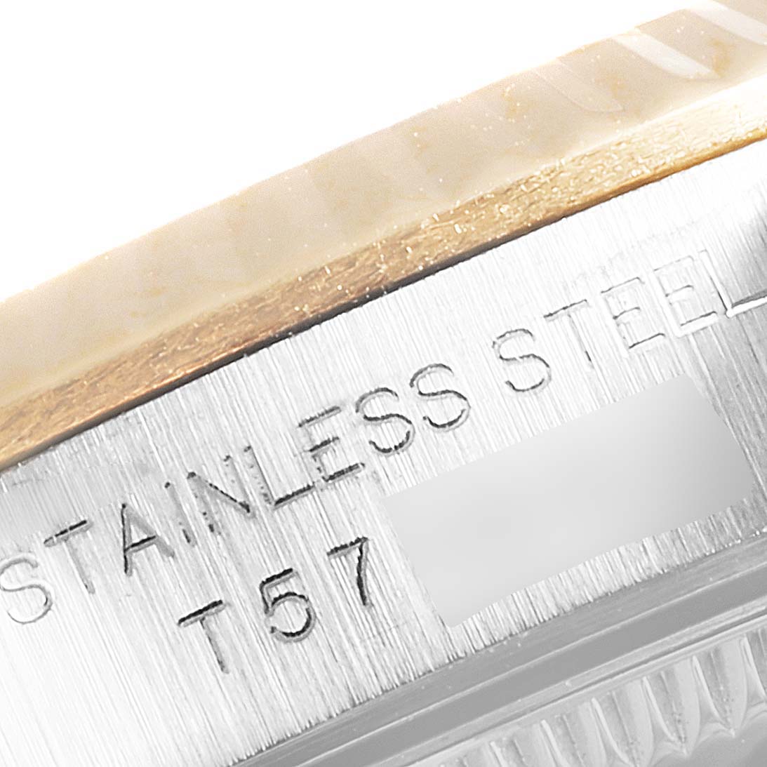 This image shows a close-up of the case side of a Rolex Oyster Perpetual 67193 Women
s Steel and Gold (two tone) Champagne Dial 67193 Women
s Steel and Gold (two tone) Champagne Dial, highlighting the engraving on the stainless steel.