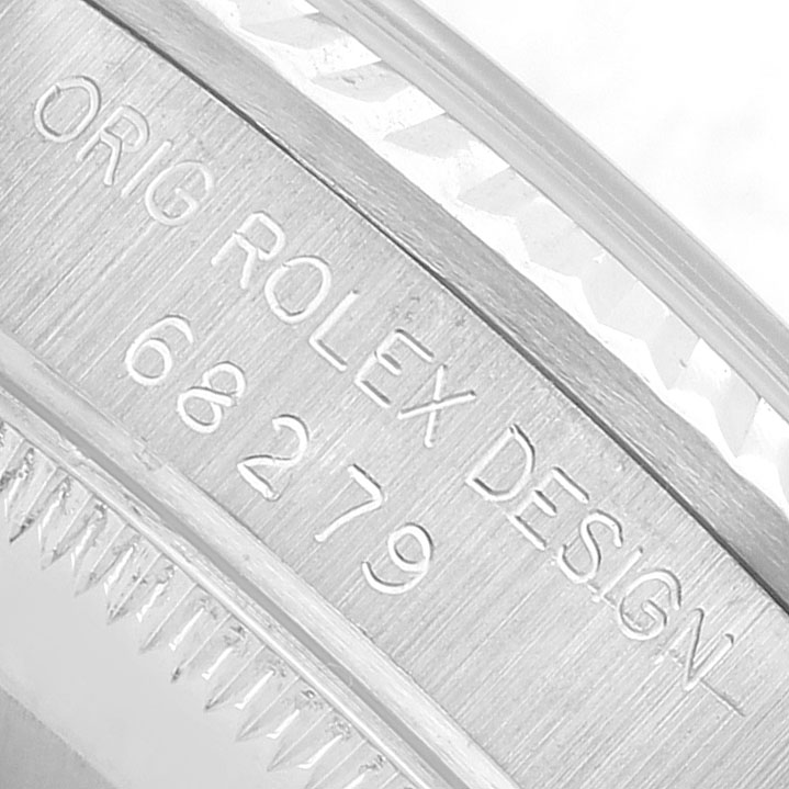 The image shows a close-up of the engraved case side of a Rolex President 68279 Women's White Gold Silver Dial watch, featuring the serial and model number.