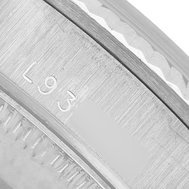 The image shows a close-up of the serial number engraving on the bezel of a Rolex President 68279 Women's White Gold Silver Dial model watch.