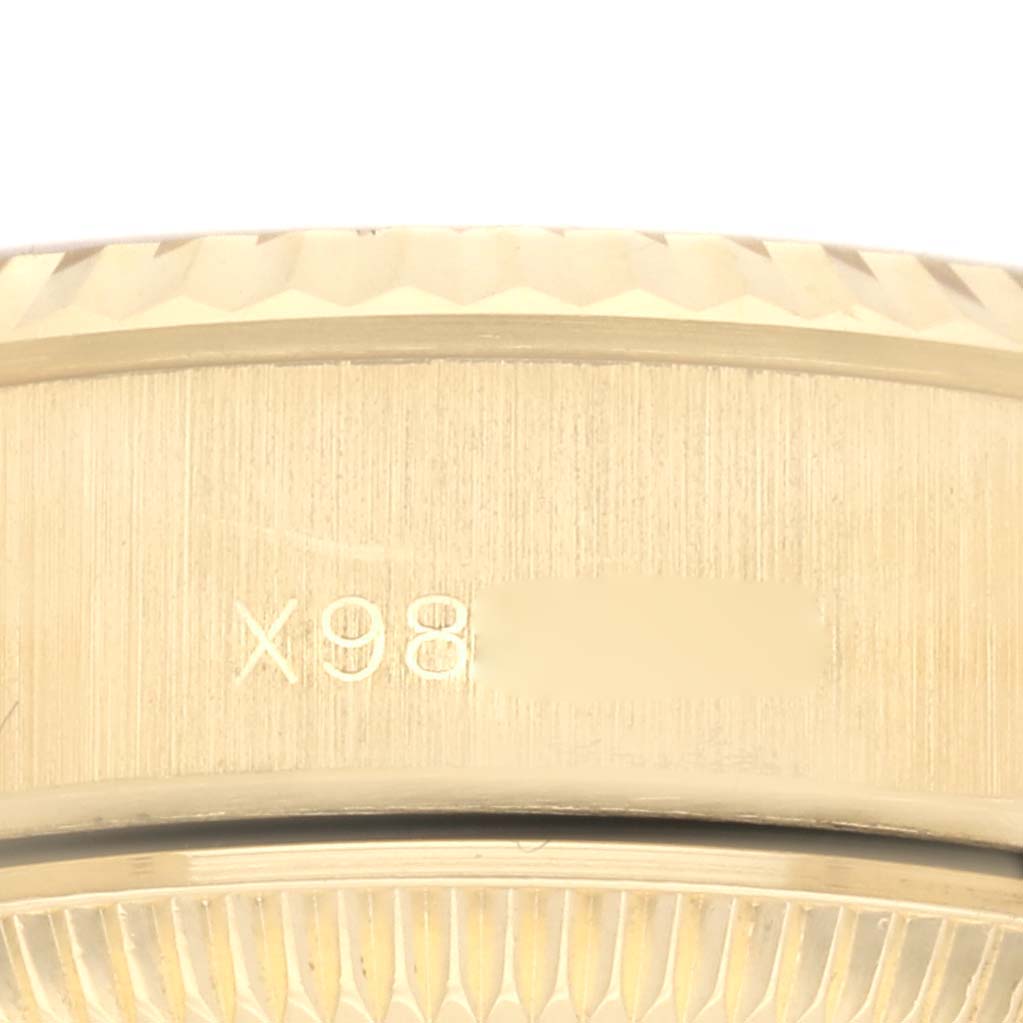 The image shows the side view of the bezel and case of a Rolex President 69178 Women's Yellow Gold Champagne Dial 69178 Women's Yellow Gold Champagne Dial watch, highlighting the serial number.