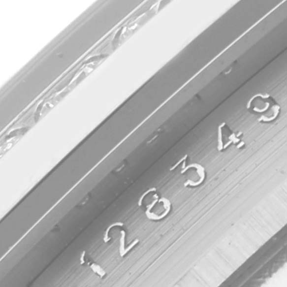 The image shows a close-up angle of the serial number engraving on the bezel of a Rolex President 128349 Men
s White Gold Blue Dial 128349 Men
s White Gold Blue Dial watch.