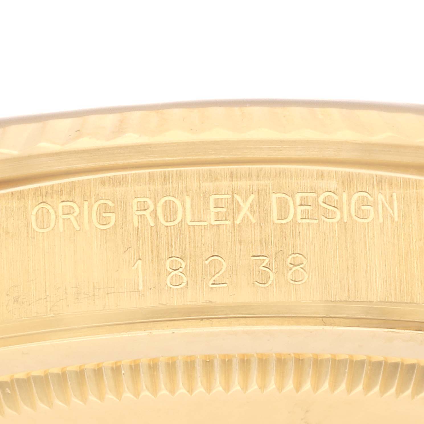 This close-up shows the engraved bezel of the Rolex President 18238 Men's Yellow Gold Champagne Dial 18238 Men's Yellow Gold Champagne Dial model, emphasizing the brand and model number 18238.