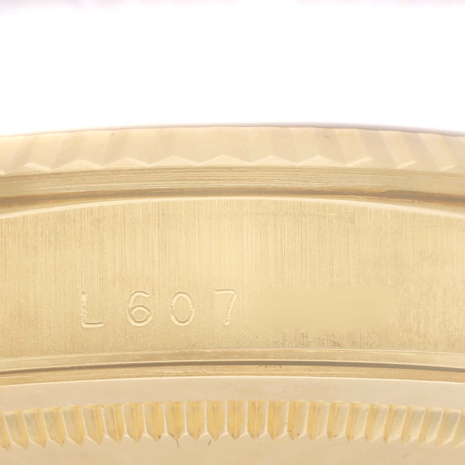 The image shows a close-up of the edge and serial number of a Rolex President 18238 Men
s Yellow Gold Champagne Dial 18238 Men
s Yellow Gold Champagne Dial watch case.