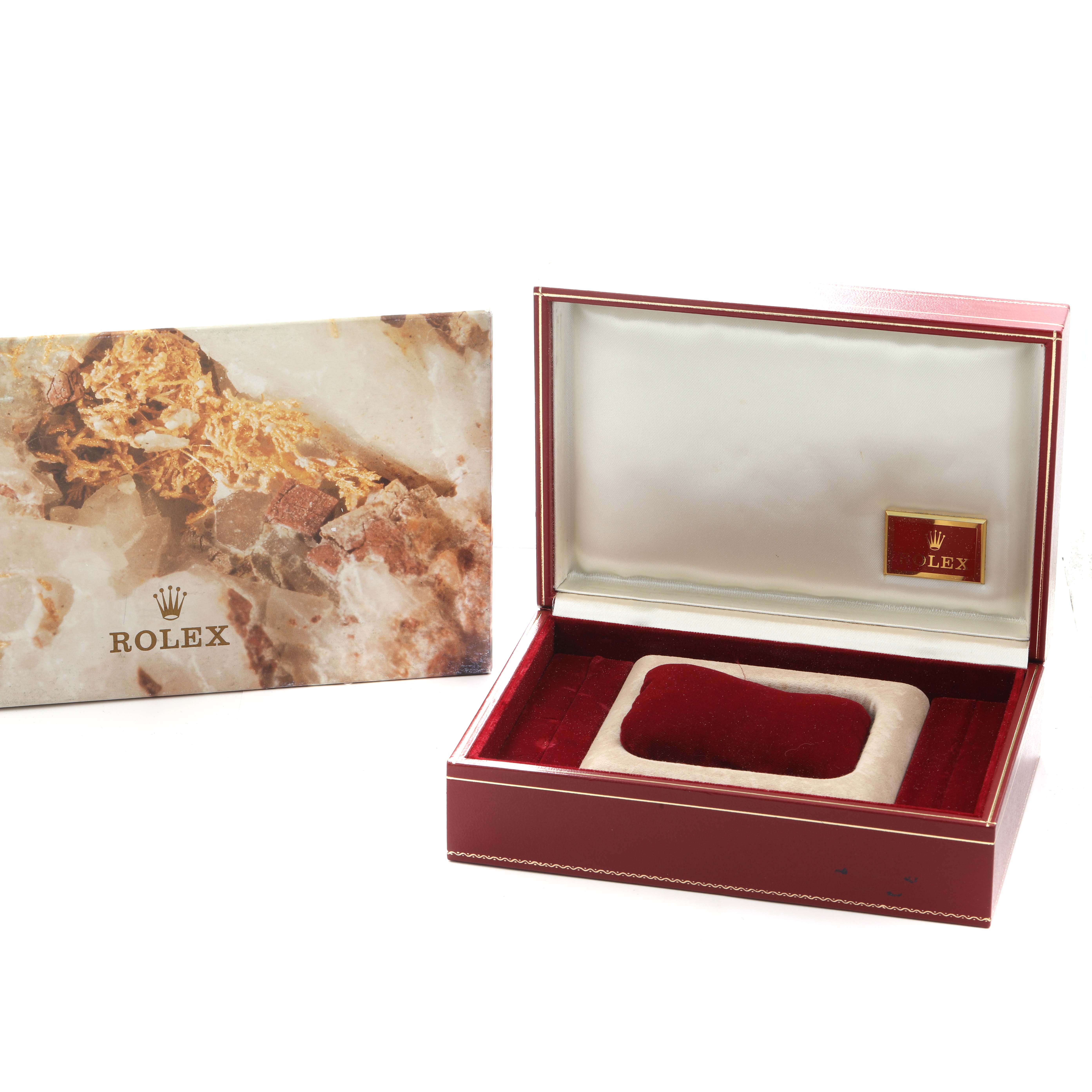 The image shows an open Rolex President 69198 Women
s Yellow Gold Champagne Dial watch box with a cushion and a decorative card nearby.