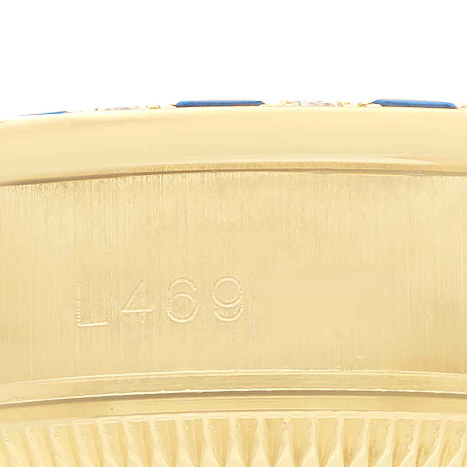 The image shows a close-up of the side case of a Rolex President 69198 Women
s Yellow Gold Champagne Dial watch, highlighting the engraved serial number.