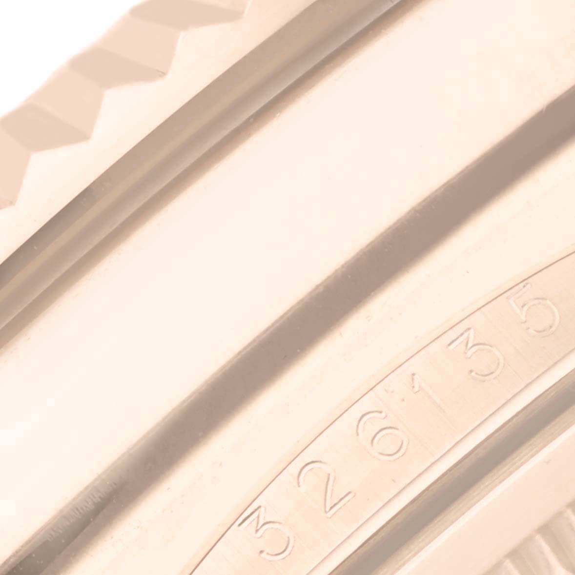 The image shows a close-up of the Rolex Sky-Dweller 326135 Men
s Rose Gold Brown Dial 326135 Men
s Rose Gold Brown Dial
s fluted bezel and partial serial number on the edge.