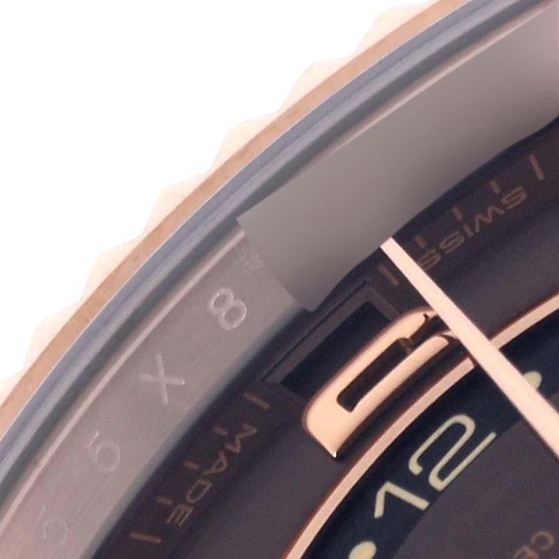 The image shows a close-up of the bezel and part of the dial of a Rolex Sky-Dweller 326135 Men
s Rose Gold Brown Dial 326135 Men
s Rose Gold Brown Dial watch, highlighting the date and month display.