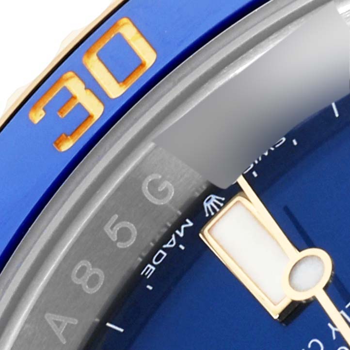 The image shows a close-up of the bezel and dial edge of the Rolex Submariner 126613 Men's Steel and Gold (two tone) Blue Dial 126613 Men's Steel and Gold (two tone) Blue Dial.