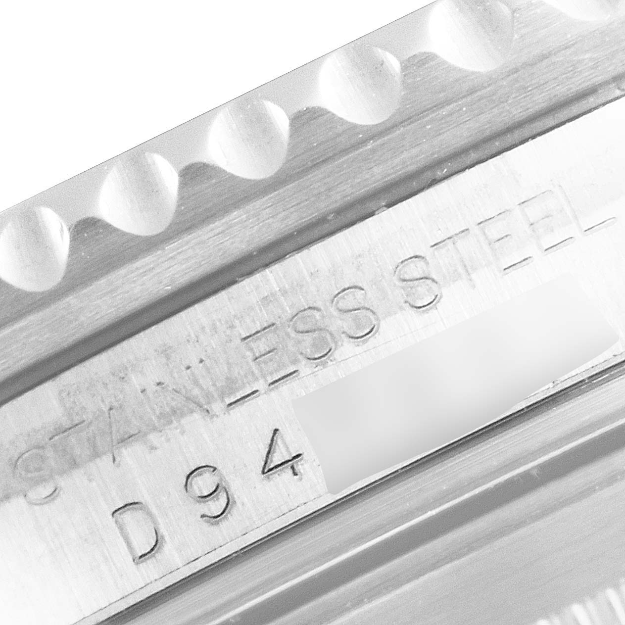 This close-up image shows the engraved bezel and case markings of a Rolex Submariner 16610 Men's Stainless Steel Black Dial 16610 Men's Stainless Steel Black Dial model.