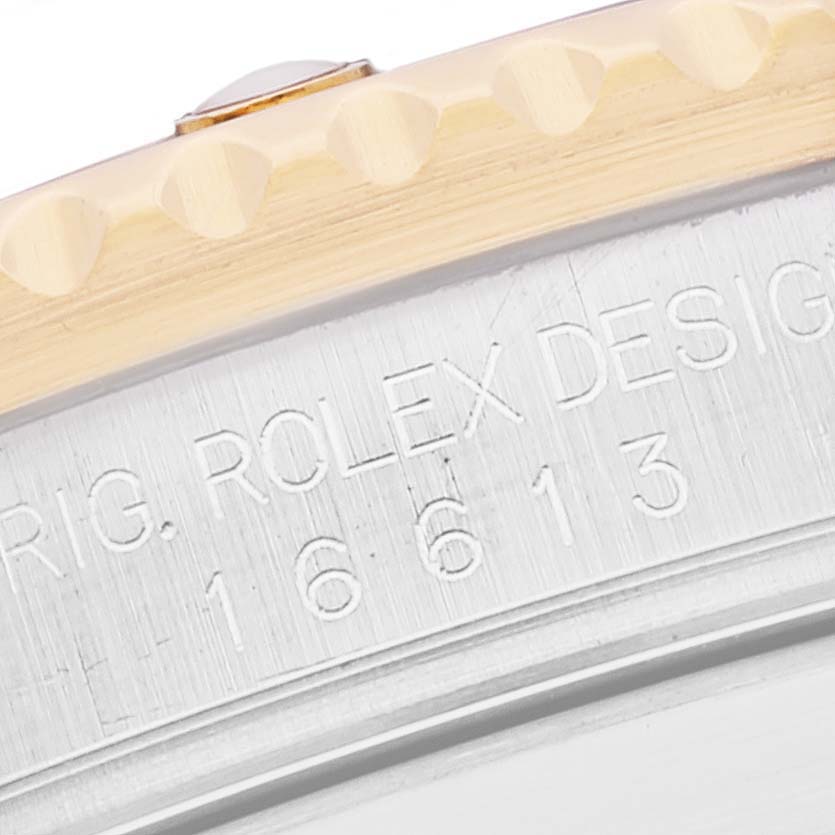 The image shows a close-up of the case and bezel of a Rolex Submariner 16613 Men's Steel and Gold (two tone) Blue Dial 16613 Men's Steel and Gold (two tone) Blue Dial watch, focused on the engraved model numbers.