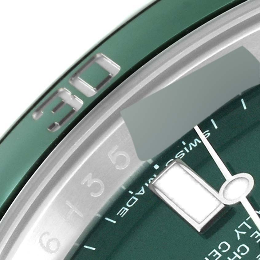 The image shows a close-up of the green bezel and part of the dial of a Rolex Submariner 116610LV Men's Stainless Steel Green Dial 116610LV Men's Stainless Steel Green Dial watch.