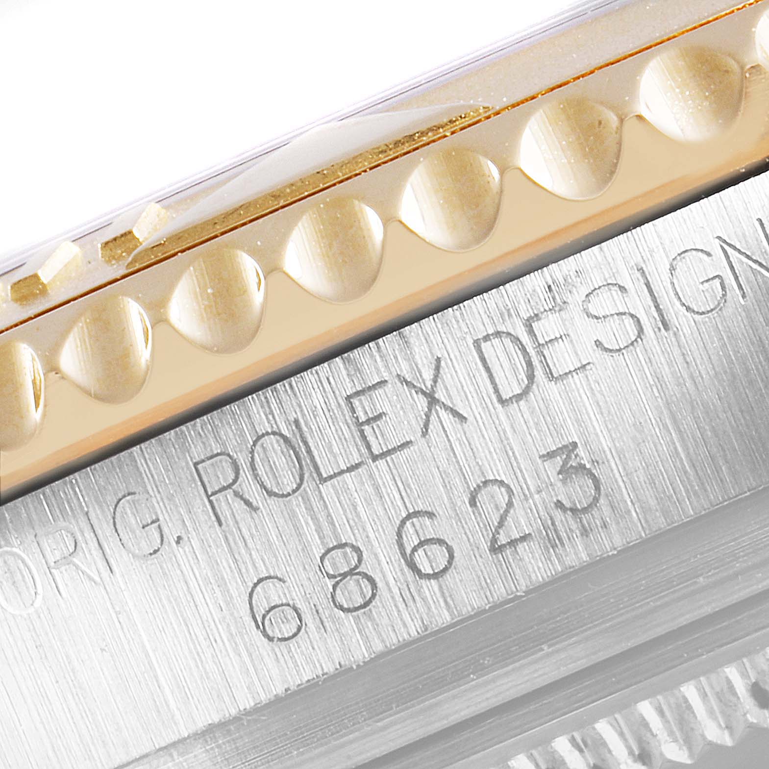 Close-up of the serial and model number engraving along with the bezel detail of a Rolex Yacht-Master 68623 Men
s Steel and Gold (two tone) Champagne Dial 68623 Men
s Steel and Gold (two tone) Champagne Dial watch.