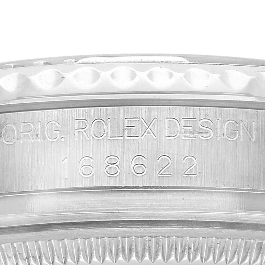 The image shows a close-up of the side engraving on a Rolex Yacht-Master 168622 Men's Stainless Steel Silver Dial watch, featuring design details and model number.
