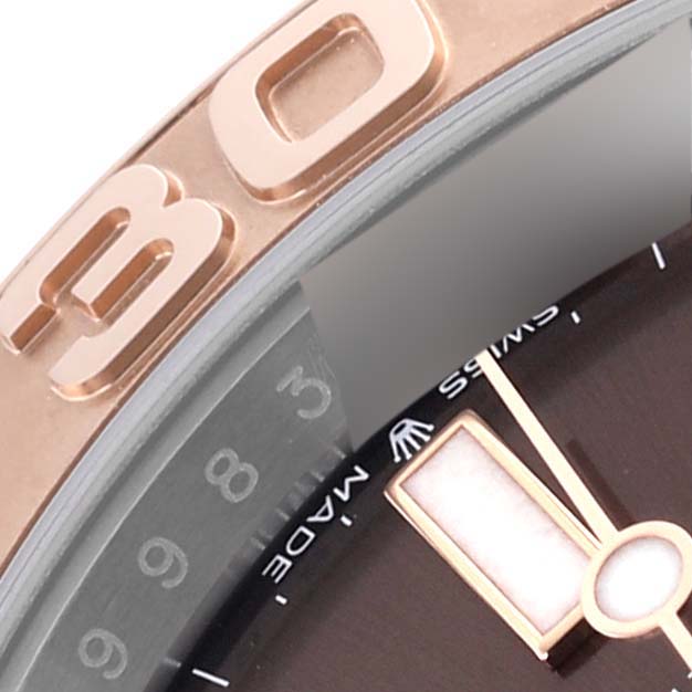 The image shows a close-up of the bezel and dial of a Rolex Yacht-Master 126621 Men's Steel and Gold (two tone) Brown Dial 126621 Men's Steel and Gold (two tone) Brown Dial watch, highlighting its numbers and hands.